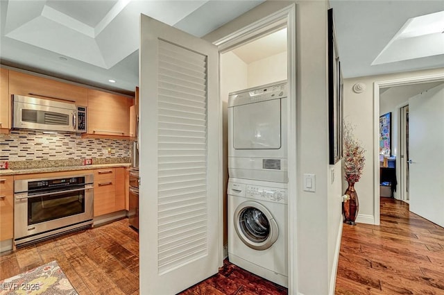 222 Karen Ave Unit 601, Las Vegas, NV 89109 - laundry room featuring stacked washing machine and dryer and wood finished floors