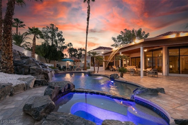 2101 Diamond Bar Dr, Las Vegas, NV 89117 - view of swimming pool featuring a patio area, a pool with connected hot tub, and an outdoor hangout area