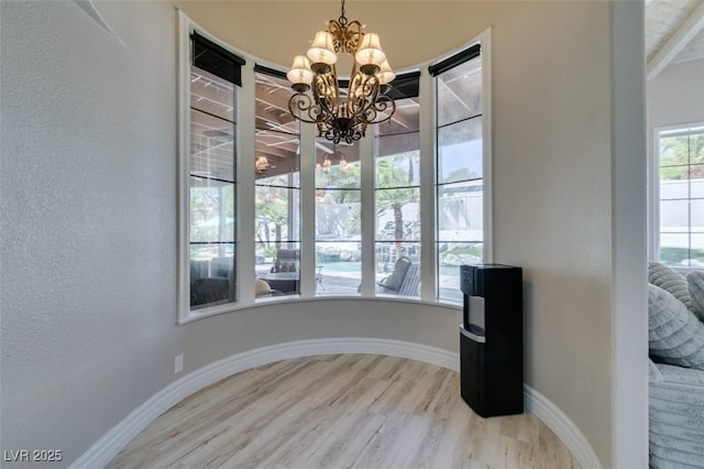 2101 Diamond Bar Dr, Las Vegas, NV 89117 - dining room featuring a chandelier, wood finished floors, and baseboards