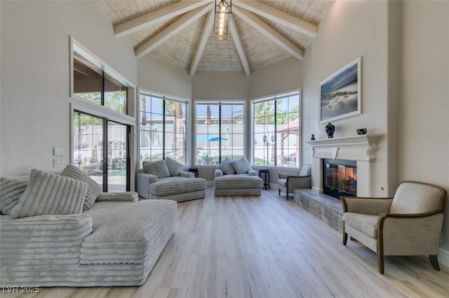 2101 Diamond Bar Dr, Las Vegas, NV 89117 - living room with a glass covered fireplace, high vaulted ceiling, wooden ceiling with exposed beams, and wood finished floors