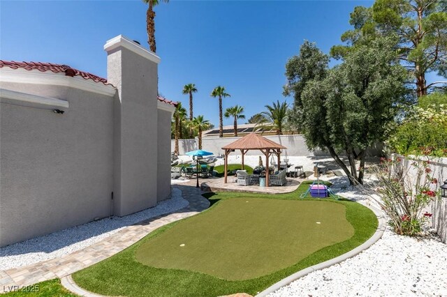 2101 Diamond Bar Dr, Las Vegas, NV 89117 - fenced yard featuring a gazebo, an area to practice putting, and a patio area