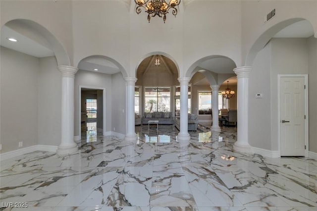 2101 Diamond Bar Dr, Las Vegas, NV 89117 - entryway featuring a towering ceiling, marble tiled flooring, a chandelier, baseboards, and arched walkways