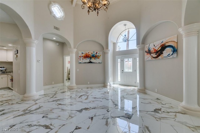 2101 Diamond Bar Dr, Las Vegas, NV 89117 - foyer with a high ceiling, light marble finish floors, decorative columns, and a chandelier