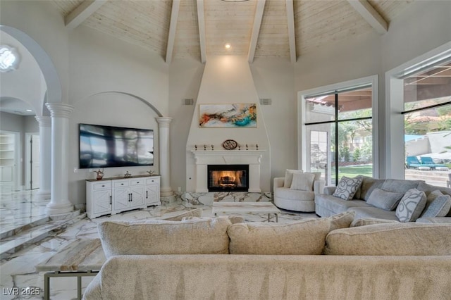 2101 Diamond Bar Dr, Las Vegas, NV 89117 - living room with high vaulted ceiling, ornate columns, wooden ceiling with exposed beams, light marble finish flooring, and arched walkways