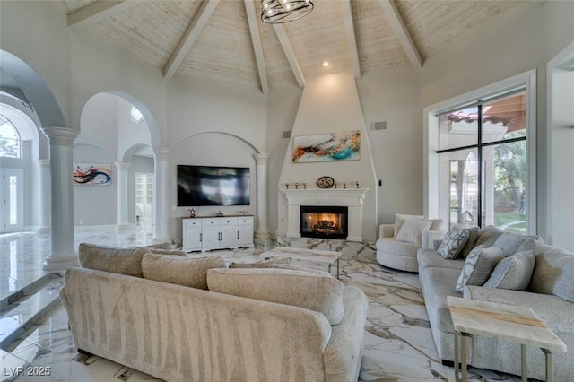 2101 Diamond Bar Dr, Las Vegas, NV 89117 - living area with ornate columns, light marble finish floors, high vaulted ceiling, wooden ceiling with exposed beams, and a premium fireplace