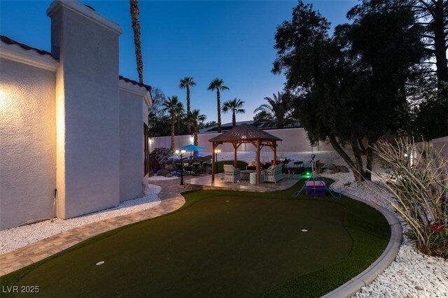 2101 Diamond Bar Dr, Las Vegas, NV 89117 - fenced backyard with a gazebo, a putting area, and a patio area