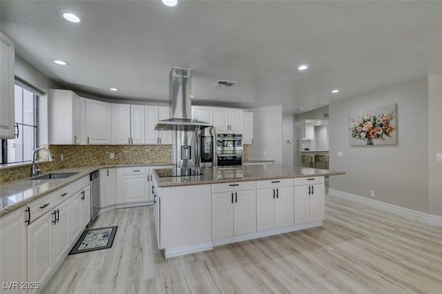 2101 Diamond Bar Dr, Las Vegas, NV 89117 - kitchen with island range hood, a sink, light wood-type flooring, a kitchen island, and stainless steel appliances