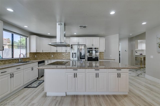 2101 Diamond Bar Dr, Las Vegas, NV 89117 - kitchen with stainless steel appliances, a sink, island range hood, a kitchen island, and white cabinetry