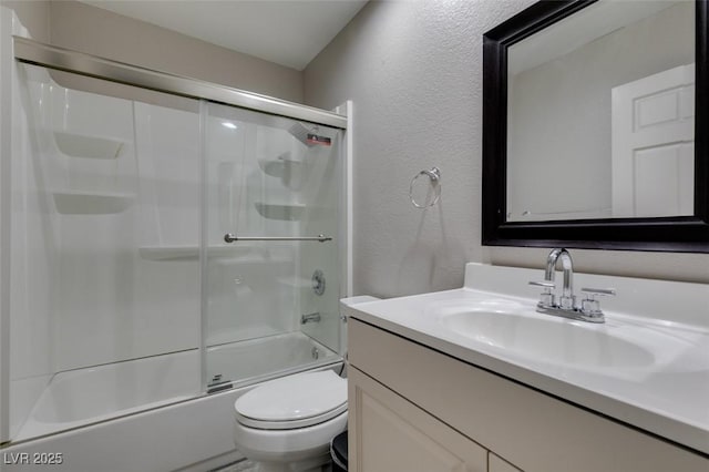2101 Diamond Bar Dr, Las Vegas, NV 89117 - bathroom featuring a textured wall, toilet, vanity, and combined bath / shower with glass door