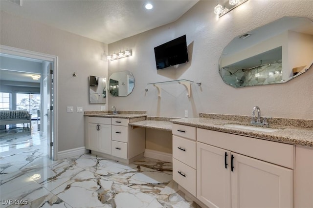 2101 Diamond Bar Dr, Las Vegas, NV 89117 - full bathroom featuring two vanities, baseboards, marble finish floors, and recessed lighting