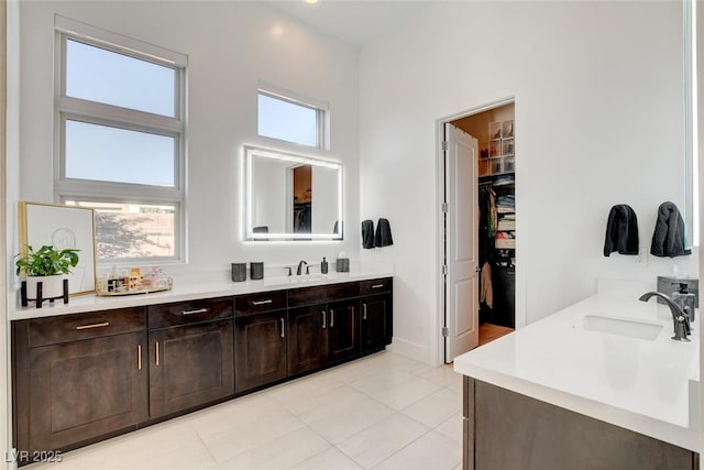 5155 Rock Daisy Dr, Las Vegas, NV 89135 - full bathroom with vanity, a spacious closet, tile patterned flooring, and baseboards
