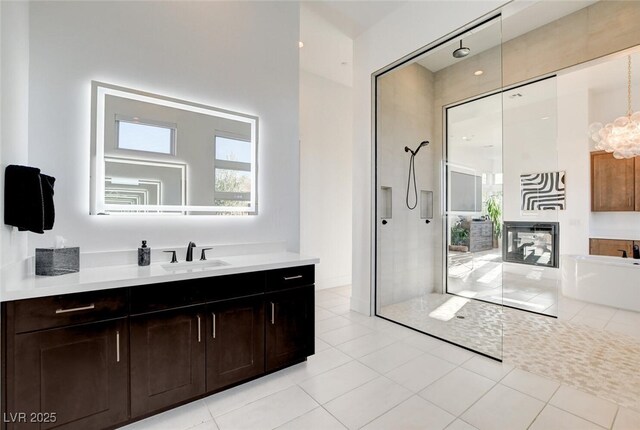 5155 Rock Daisy Dr, Las Vegas, NV 89135 - full bathroom featuring vanity, walk in shower, a freestanding bath, a chandelier, and tile patterned flooring