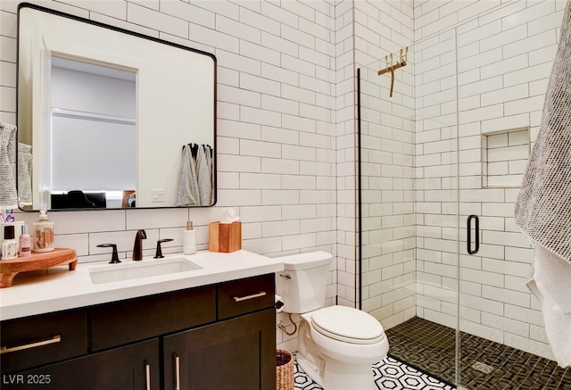 5155 Rock Daisy Dr, Las Vegas, NV 89135 - full bath with a stall shower, vanity, tile walls, toilet, and tasteful backsplash