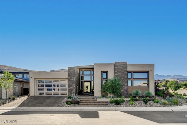 5155 Rock Daisy Dr, Las Vegas, NV 89135 - contemporary house featuring stucco siding, a garage, driveway, and a mountain view