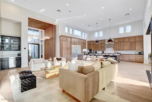 5155 Rock Daisy Dr, Las Vegas, NV 89135 - living area featuring a towering ceiling, light wood-style flooring, and recessed lighting