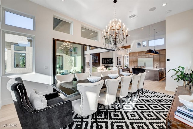 5155 Rock Daisy Dr, Las Vegas, NV 89135 - dining space featuring a chandelier, a high ceiling, light wood-style floors, and recessed lighting
