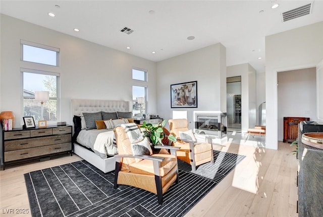 5155 Rock Daisy Dr, Las Vegas, NV 89135 - bedroom featuring light wood-style floors, multiple windows, recessed lighting, and a towering ceiling