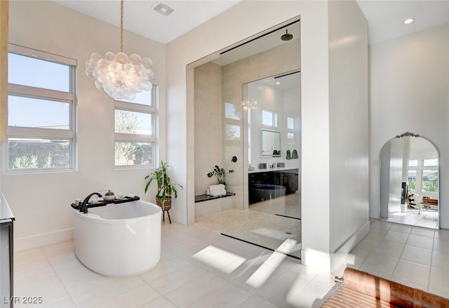5155 Rock Daisy Dr, Las Vegas, NV 89135 - full bath with a chandelier, vanity, a freestanding bath, baseboards, and tile patterned flooring