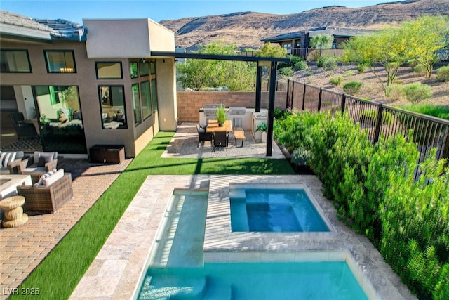 5155 Rock Daisy Dr, Las Vegas, NV 89135 - back of house featuring an outdoor hangout area, stucco siding, an in-ground hot tub, and a patio