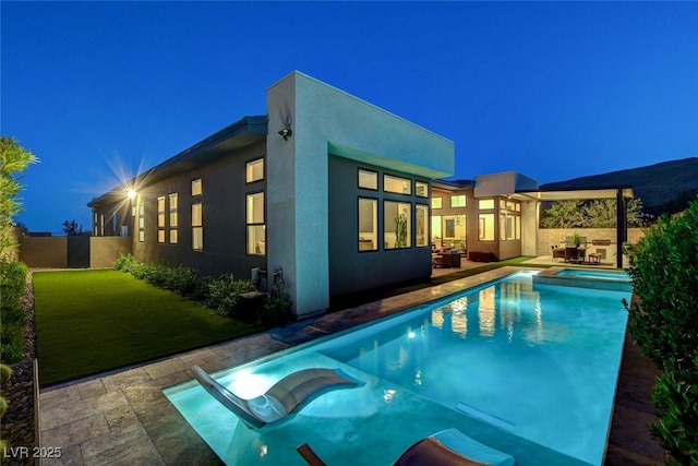 5155 Rock Daisy Dr, Las Vegas, NV 89135 - pool at twilight featuring a patio and a pool with connected hot tub
