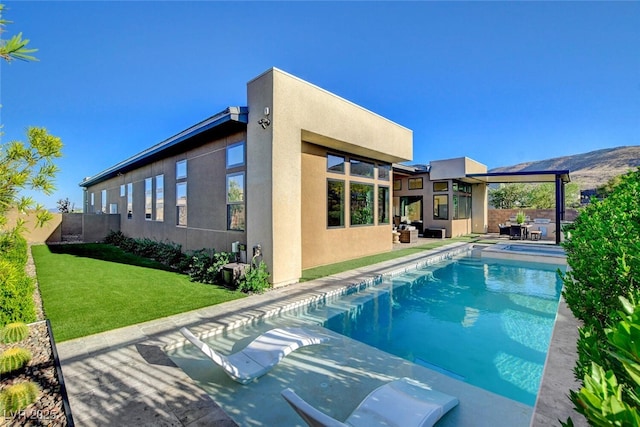 5155 Rock Daisy Dr, Las Vegas, NV 89135 - rear view of house featuring stucco siding, a patio, and a pool with connected hot tub