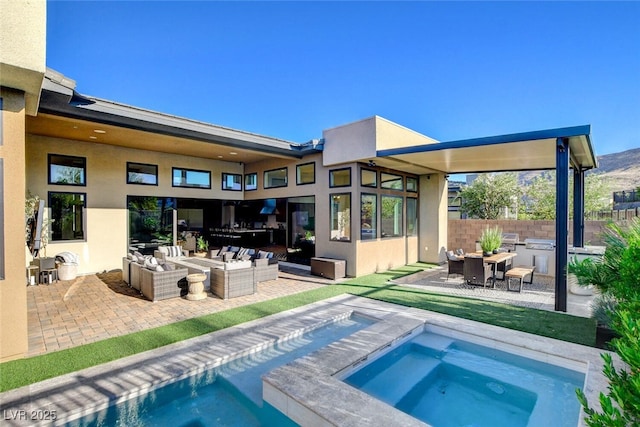 5155 Rock Daisy Dr, Las Vegas, NV 89135 - back of house with an outdoor hangout area, stucco siding, an in-ground hot tub, and a patio