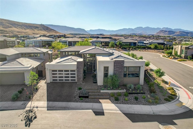5155 Rock Daisy Dr, Las Vegas, NV 89135 - view of front of home featuring decorative driveway, stucco siding, a garage, and a mountain view