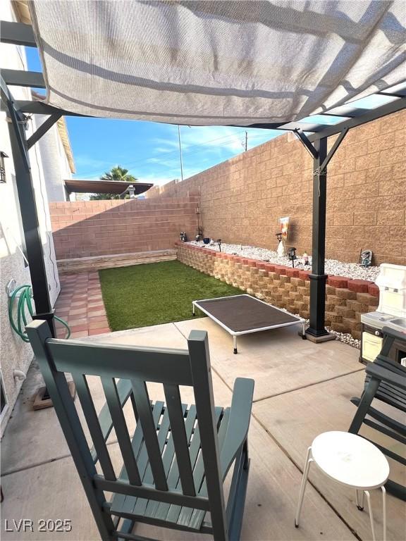 779 Peregrine Falcon St, Henderson, NV 89015 - fenced backyard with a pergola and a patio