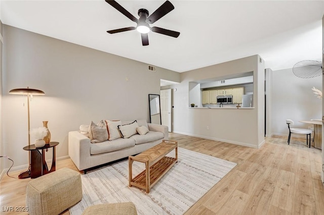 8000 Badura Ave Unit 1007, Las Vegas, NV 89113 - living room with ceiling fan and light wood-style floors