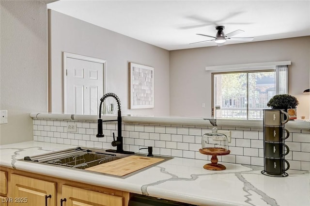 8000 Badura Ave Unit 1007, Las Vegas, NV 89113 - kitchen with backsplash, ceiling fan, light stone counters, and light brown cabinetry