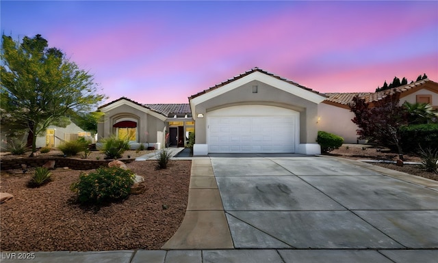 2816 High Range Dr, Las Vegas, NV 89134 - view of front of house featuring stucco siding, a tile roof, driveway, and an attached garage