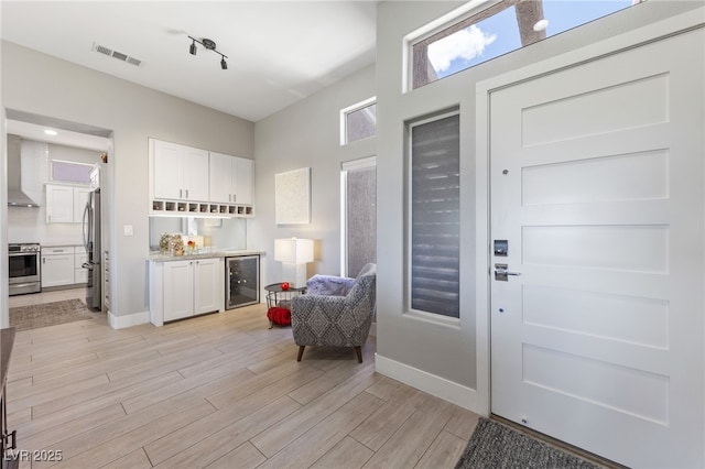 2816 High Range Dr, Las Vegas, NV 89134 - foyer entrance with wine cooler, light wood-style floors, a dry bar, and baseboards