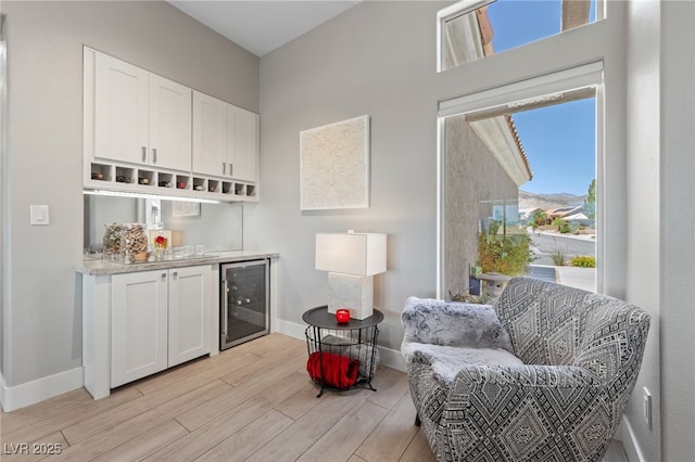 2816 High Range Dr, Las Vegas, NV 89134 - indoor dry bar with beverage cooler, light wood-type flooring, and baseboards