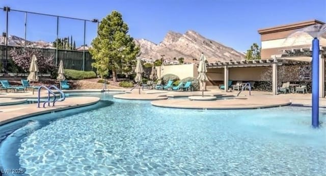 2816 High Range Dr, Las Vegas, NV 89134 - community pool featuring a mountain view, a patio, and a pergola