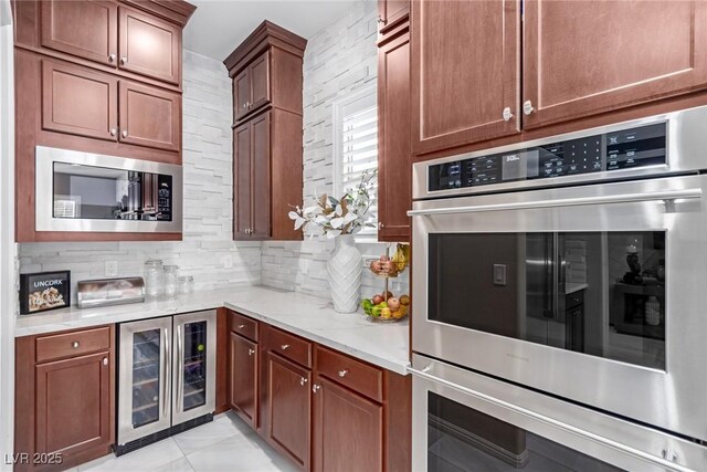 3929 Reyes Ave, Las Vegas, NV 89141 - kitchen with wine cooler, stainless steel appliances, decorative backsplash, and light stone countertops