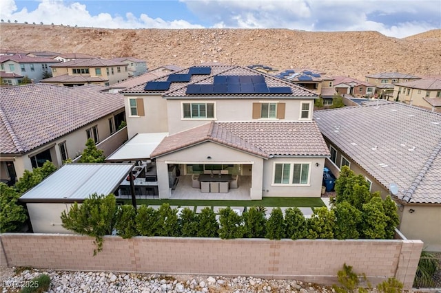 3929 Reyes Ave, Las Vegas, NV 89141 - back of property featuring roof mounted solar panels, a residential view, stucco siding, a tile roof, and a fenced backyard