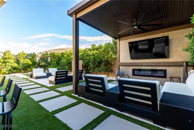 3929 Reyes Ave, Las Vegas, NV 89141 - view of patio / terrace featuring an outdoor living space with a fireplace and ceiling fan