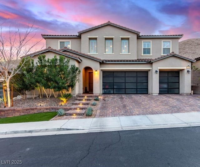 3929 Reyes Ave, Las Vegas, NV 89141 - view of front facade with a tiled roof, a garage, stucco siding, and decorative driveway