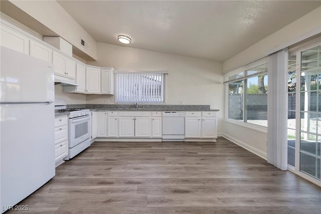 5535 Oxbow St, Las Vegas, NV 89119 - kitchen with white appliances, white cabinetry, under cabinet range hood, a sink, and light wood-style floors