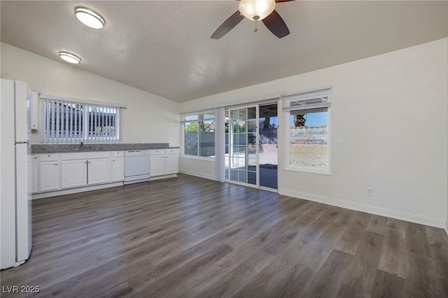 5535 Oxbow St, Las Vegas, NV 89119 - unfurnished living room featuring vaulted ceiling, a ceiling fan, dark wood-style floors, baseboards, and a sink