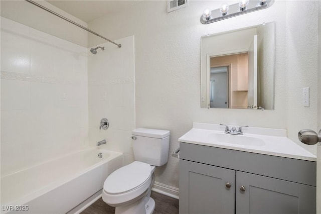 5535 Oxbow St, Las Vegas, NV 89119 - bathroom featuring toilet, vanity, bathing tub / shower combination, baseboards, and a textured wall
