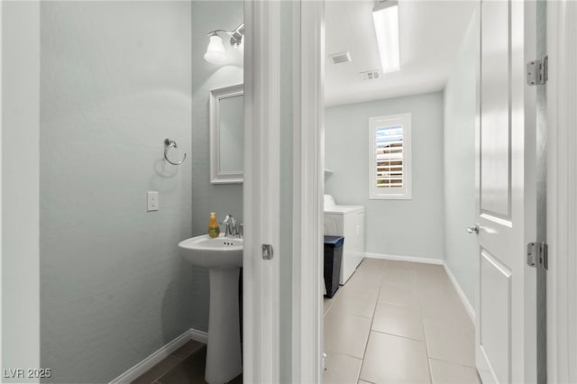 424 Vigo Port St, Las Vegas, NV 89138 - half bath featuring washing machine and clothes dryer, tile patterned floors, a sink, and baseboards