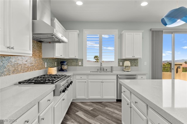 424 Vigo Port St, Las Vegas, NV 89138 - kitchen featuring wall chimney exhaust hood, stainless steel appliances, a sink, wood finished floors, and light countertops