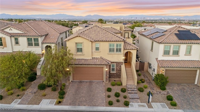 424 Vigo Port St, Las Vegas, NV 89138 - mediterranean / spanish-style house featuring an attached garage, stucco siding, decorative driveway, and a tiled roof