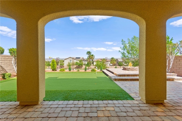 424 Vigo Port St, Las Vegas, NV 89138 - fenced backyard with a putting green and a patio area