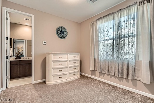 2507 Silent View Ave, Henderson, NV 89044 - bedroom featuring light carpet, baseboards, ensuite bathroom, and a sink