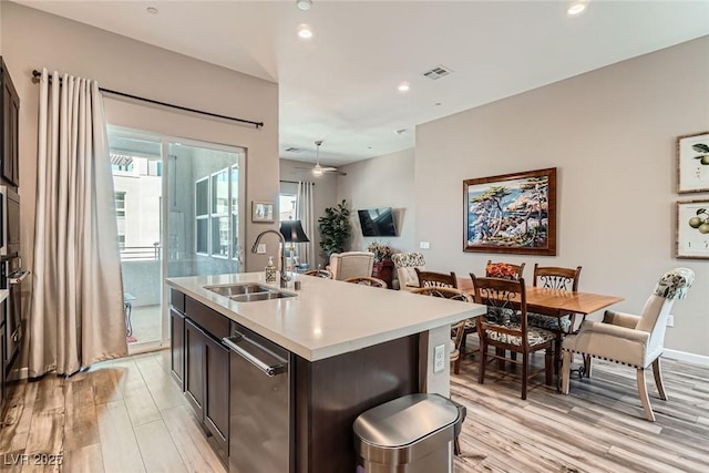 2507 Silent View Ave, Henderson, NV 89044 - kitchen featuring a sink, dishwasher, light wood-style floors, recessed lighting, and a center island with sink