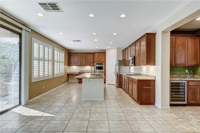 5949 Casa Coronado Ave, Las Vegas, NV 89131 - kitchen with beverage cooler, stainless steel appliances, a sink, light stone countertops, and light tile patterned floors