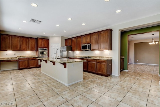 5949 Casa Coronado Ave, Las Vegas, NV 89131 - kitchen with appliances with stainless steel finishes, light tile patterned floors, recessed lighting, a kitchen breakfast bar, and a sink