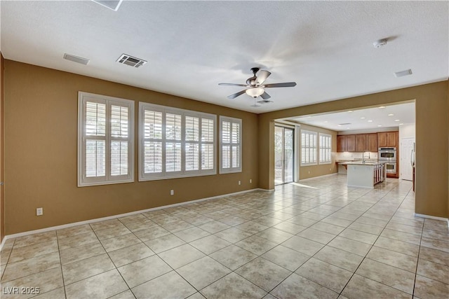 5949 Casa Coronado Ave, Las Vegas, NV 89131 - unfurnished living room with ceiling fan, light tile patterned floors, and baseboards